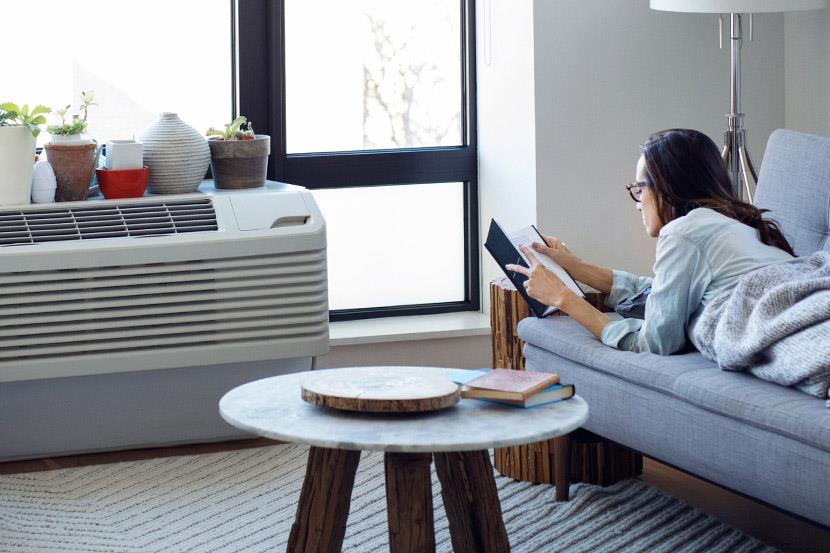 woman stretched out on sofa reading